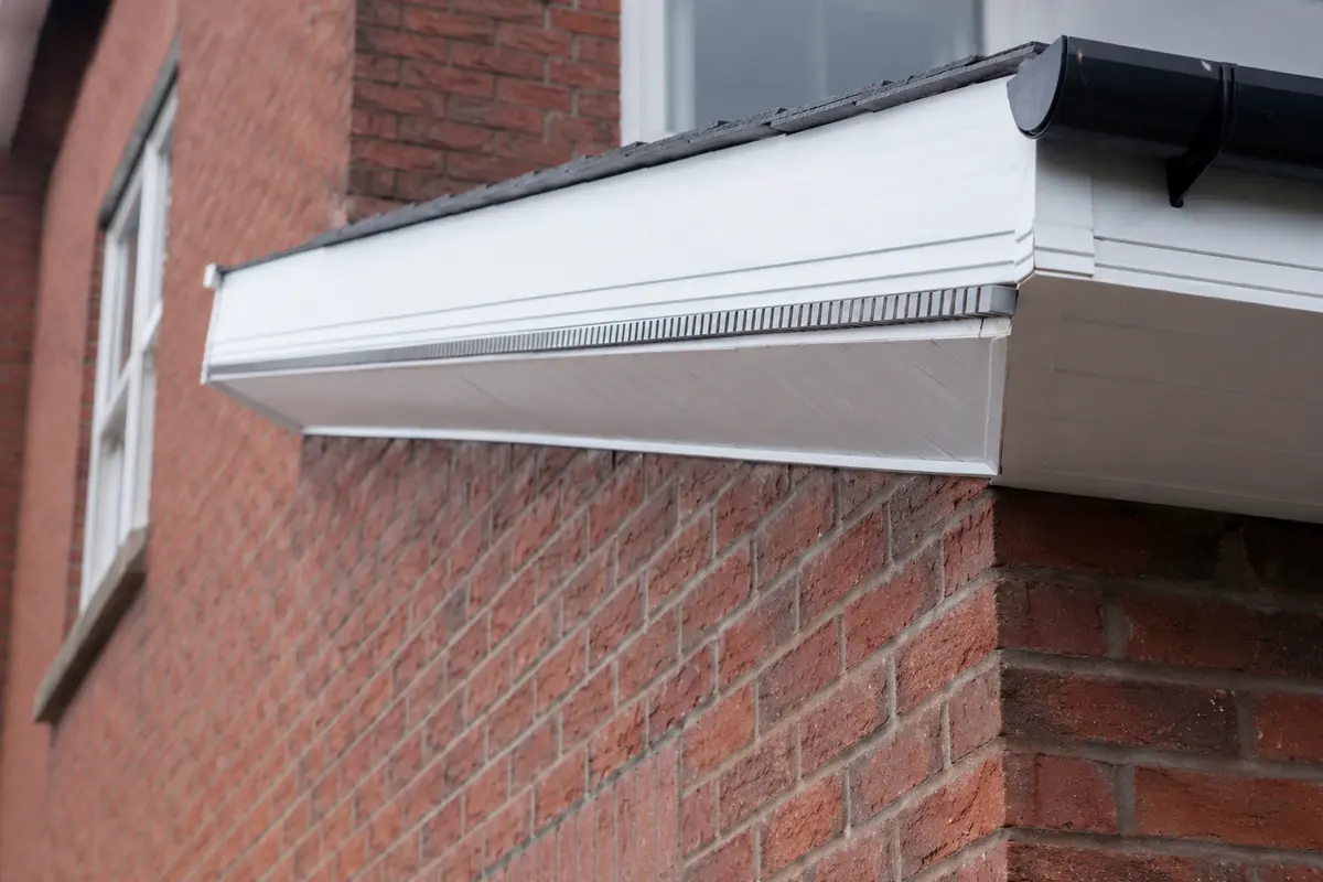 Close detail of uPVC fascia, vented soffit and over-fascia vent at the eaves