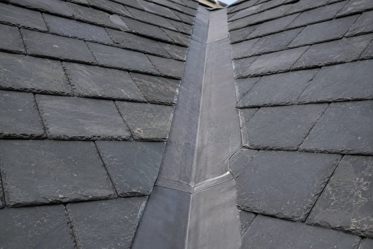 Lead-lined open valley running between two pitched roof slopes