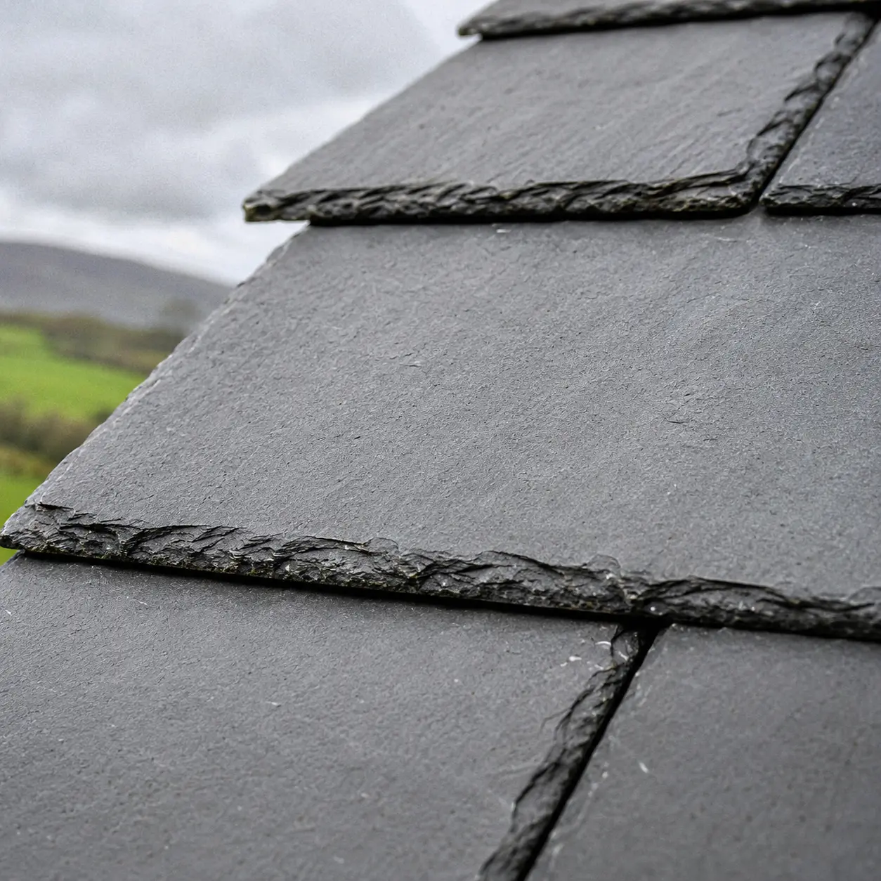 Black uPVC guttering and downpipe on a rendered house
